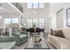 Bright open-concept living room with vaulted ceilings, dining area, sliding door and comfortable seating at 10524 Eby Cir, Lone Tree, CO 80124