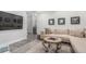Comfortable living room featuring a sectional couch, gray flooring, and wall decor at 10524 Eby Cir, Lone Tree, CO 80124