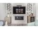 Stylish living room featuring a modern fireplace, TV, and sleek cabinetry with a small wet bar at 10524 Eby Cir, Lone Tree, CO 80124