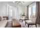 A modern living room featuring French doors and open space for conversation at 10524 Eby Cir, Lone Tree, CO 80124
