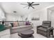 Upstairs living area featuring neutral tones, comfortable seating, ceiling fan, and natural light at 10524 Eby Cir, Lone Tree, CO 80124