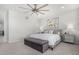 Bright main bedroom features neutral tones, ceiling fan, and a comfortable seating area at 10524 Eby Cir, Lone Tree, CO 80124