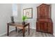 Bright office featuring a wooden desk, hardwood floors, a decorative hutch, and a large, framed graphic at 10524 Eby Cir, Lone Tree, CO 80124