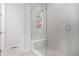 Modern bathroom featuring a glass enclosed shower with a built-in seat and neutral tile work at 10524 Eby Cir, Lone Tree, CO 80124