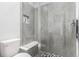 Bathroom featuring a shower with a built-in seat, sleek design, and neutral tile work at 10524 Eby Cir, Lone Tree, CO 80124