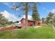 Exterior of a home with a lawn and landscaping, and a view of trees and blue sky at 6293 Ponderosa Way, Parker, CO 80134