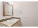 Bright bathroom featuring a vanity with tile countertop and large mirror at 6293 Ponderosa Way, Parker, CO 80134
