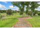 Scenic view of a community park with pathways, benches, mature trees, and grassy areas at 6293 Ponderosa Way, Parker, CO 80134