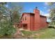 Side exterior view of the home with a chimney, a roofed patio, and green spaces at 6293 Ponderosa Way, Parker, CO 80134
