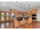 Gourmet kitchen featuring stainless steel appliances, custom cabinetry, and granite countertops at 6293 Ponderosa Way, Parker, CO 80134