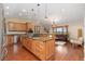 Spacious open kitchen with island and breakfast bar adjoining the living area at 6293 Ponderosa Way, Parker, CO 80134