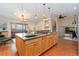 Large kitchen island, granite countertops, and stainless appliances, flowing into the living area at 6293 Ponderosa Way, Parker, CO 80134