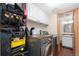 Efficient laundry area featuring washer and dryer with storage solutions at 6293 Ponderosa Way, Parker, CO 80134