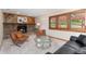 Spacious living room with stone fireplace, wood accent wall, and plentiful seating at 6293 Ponderosa Way, Parker, CO 80134