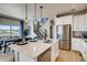 Modern kitchen with stainless steel appliances, island, and an adjacent dining area at 23772 E 33Rd Pl, Aurora, CO 80019