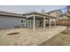 Backyard features a covered patio and gray siding on the house at 6009 Yarrow St # B, Arvada, CO 80004