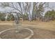 A backyard view with disc golf setup, mature trees, and natural landscape at 6009 Yarrow St # B, Arvada, CO 80004