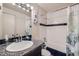 Bathroom featuring a tiled tub, shower, granite countertop, and modern mirror for a relaxing experience at 6009 Yarrow St # B, Arvada, CO 80004