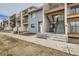 View of townhome complex with private exterior stairs, and a combination of siding finishes at 6009 Yarrow St # B, Arvada, CO 80004
