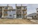 View of townhome complex featuring siding, black iron balconies and stairs to the upper units at 6009 Yarrow St # B, Arvada, CO 80004