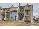 View of townhome complex featuring siding, black iron balconies and stairs to the upper units at 6009 Yarrow St # B, Arvada, CO 80004