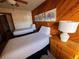 Comfortable bedroom featuring twin beds with soft lighting and wood paneling at 305 S Park Ave # 402, Breckenridge, CO 80424
