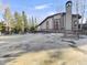 Exterior shot of deck with grill and outdoor dining space with pine trees in background at 305 S Park Ave # 402, Breckenridge, CO 80424