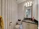 Half bathroom with vanity and decorative wallpaper at 1011 N Pennsylvania St # H, Denver, CO 80203