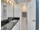 Bathroom featuring white cabinets, granite countertop, and toilet at 1011 N Pennsylvania St # H, Denver, CO 80203