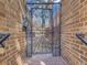 Secured entry gate with brick surround, providing privacy and security at 1011 N Pennsylvania St # H, Denver, CO 80203