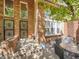 Brick townhouse exterior with covered patio and iron security doors at 1011 N Pennsylvania St # H, Denver, CO 80203