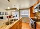Bright kitchen featuring granite countertops, stainless steel appliances, and an island sink overlooking the living area at 1011 N Pennsylvania St # H, Denver, CO 80203