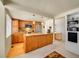Well-lit kitchen with wood cabinets, granite countertops, stainless steel appliances, and an adjacent dining area at 1011 N Pennsylvania St # H, Denver, CO 80203