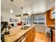 Contemporary kitchen with granite counters, stainless appliances, wood floors, and view to adjacent living room at 1011 N Pennsylvania St # H, Denver, CO 80203