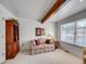Cozy living room featuring wood beam, natural light, and carpeted floors at 1011 N Pennsylvania St # H, Denver, CO 80203