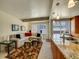 Bright living room next to kitchen boasts comfortable seating, modern lighting and a colorful rug at 1011 N Pennsylvania St # H, Denver, CO 80203