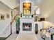 Inviting living room with a white-painted brick fireplace, mantle and hearth, complemented by a neutral color palette and plush rug at 1011 N Pennsylvania St # H, Denver, CO 80203
