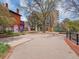 Inviting park area featuring walking paths and a variety of signage and mature trees at 1011 N Pennsylvania St # H, Denver, CO 80203