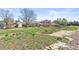Wide backyard with a concrete area, green lawn, storage sheds, and fencing for a private outdoor space at 1853 S Zeno Way, Aurora, CO 80017