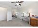 Bedroom with ceiling fan, neutral carpet, desk area, and mirrored closet at 1853 S Zeno Way, Aurora, CO 80017