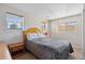 Comfortable bedroom with natural light, a full bed, and a nightstand at 1853 S Zeno Way, Aurora, CO 80017