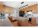 This kitchen features light wood cabinets, a kitchen island and stainless steel appliances at 1853 S Zeno Way, Aurora, CO 80017