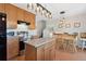 Bright eat-in kitchen features wood cabinets, a kitchen island and stainless steel appliances at 1853 S Zeno Way, Aurora, CO 80017