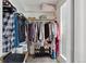Walk-in closet features shelving, shoe rack, and hanging storage at 1853 S Zeno Way, Aurora, CO 80017