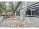 Back deck featuring the home's exterior with wood-paneled walls, windows, and surrounding trees at 29762 Spruce Rd, Evergreen, CO 80439