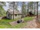 A quaint backyard with a small yard, mature trees and a shed at 29762 Spruce Rd, Evergreen, CO 80439