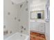 This bathroom features tile and a shower with a white vanity and modern light fixture at 29762 Spruce Rd, Evergreen, CO 80439