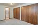 This carpeted bedroom boasts a view into an ensuite bathroom with vanity at 29762 Spruce Rd, Evergreen, CO 80439