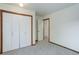 This bedroom features neutral carpet and a double door closet at 29762 Spruce Rd, Evergreen, CO 80439