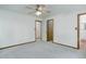 A bedroom featuring neutral walls, carpet, and wood trim around the doors and baseboards at 29762 Spruce Rd, Evergreen, CO 80439